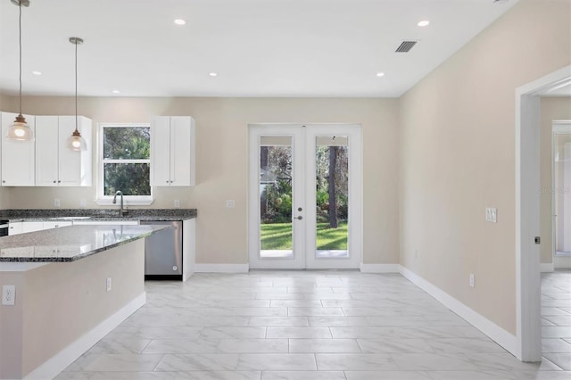 kitchen with dishwasher, french doors, white cabinets, hanging light fixtures, and dark stone countertops