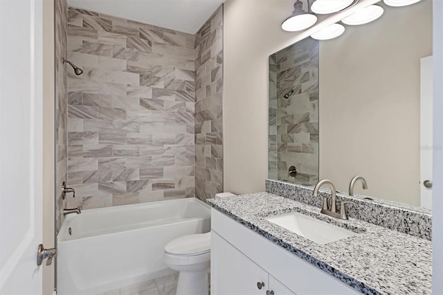 full bathroom with vanity, toilet, and tiled shower / bath