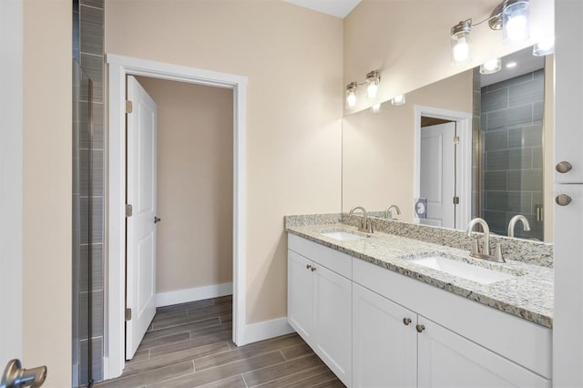 bathroom with vanity and a shower with shower door