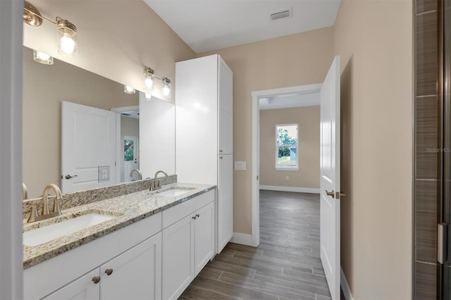 bathroom with vanity and hardwood / wood-style floors