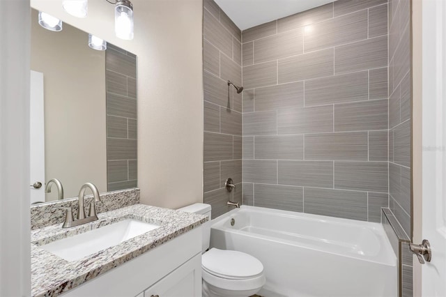 full bathroom with vanity, toilet, and tiled shower / bath combo