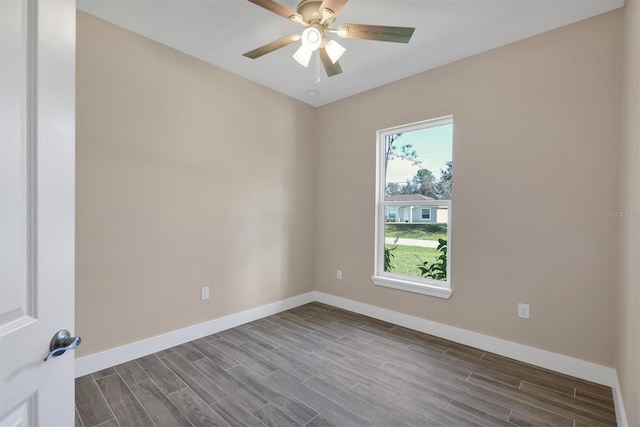 spare room featuring hardwood / wood-style floors and ceiling fan