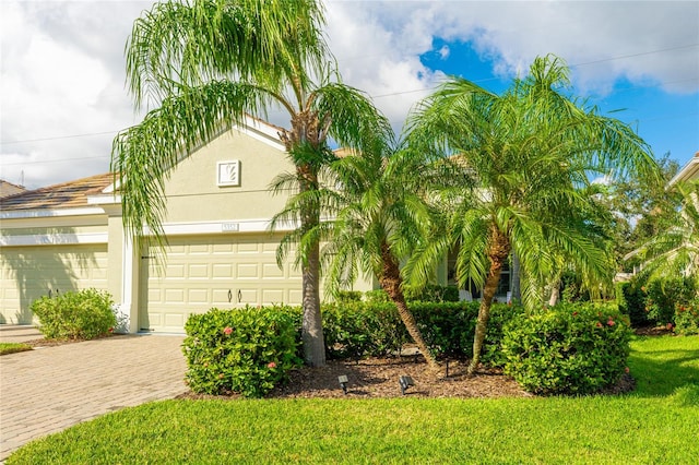 view of front of house with a garage and a front yard