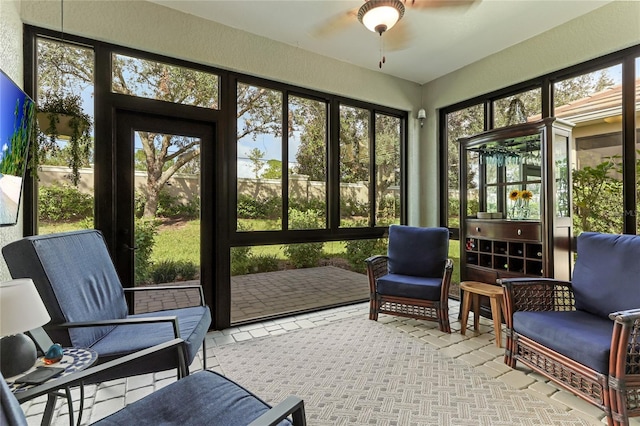 sunroom featuring ceiling fan