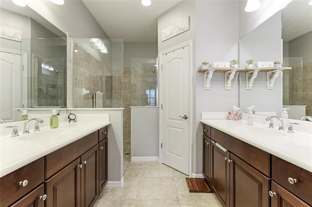 bathroom featuring vanity, tile patterned floors, and a tile shower