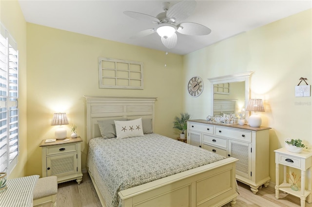 bedroom featuring light hardwood / wood-style flooring, multiple windows, and ceiling fan