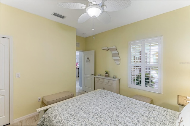 bedroom with light wood-type flooring and ceiling fan