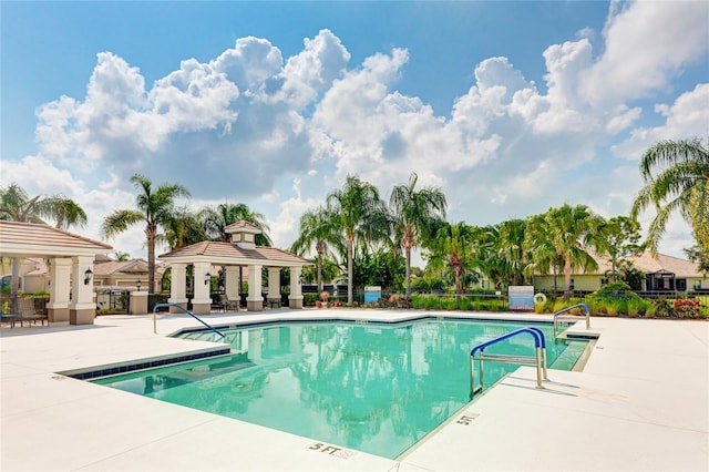 view of swimming pool featuring a patio and a gazebo