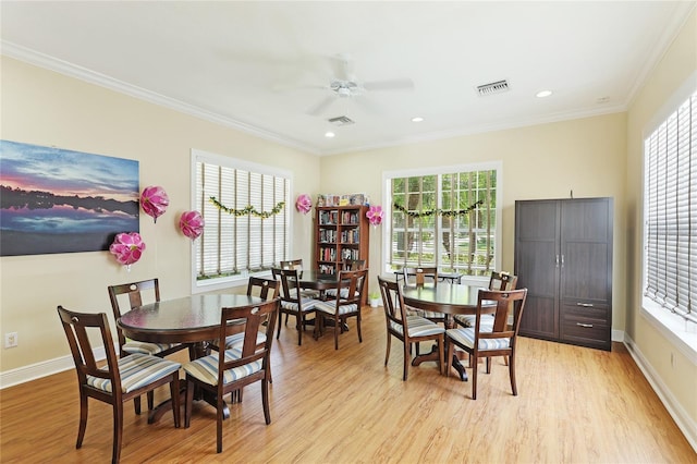 dining space featuring ceiling fan, ornamental molding, and light hardwood / wood-style flooring