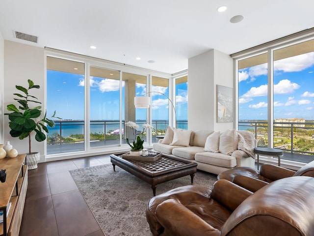 540 N Tamiami Trl Unit 1201, Sarasota, FL 34236 - living area featuring expansive windows, a water view, dark tile patterned floors, and recessed lighting