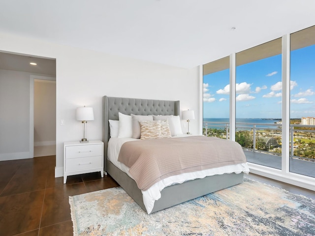 tiled bedroom with a water view and access to outside