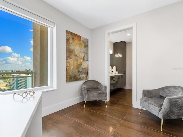 sitting room featuring dark tile patterned floors