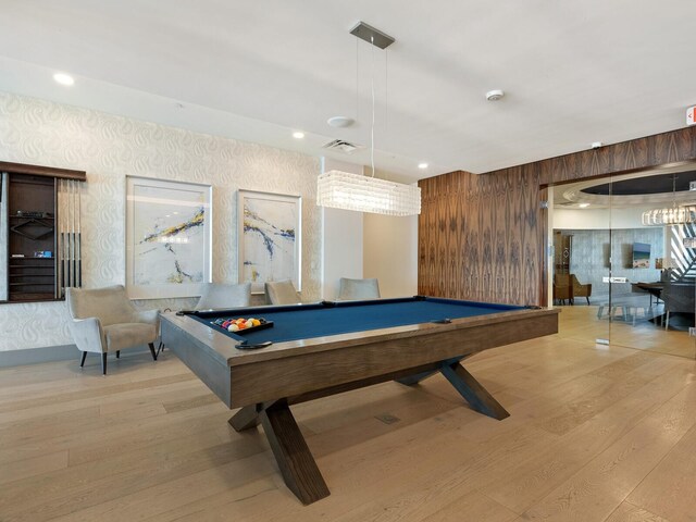 game room featuring billiards, wood walls, and light hardwood / wood-style flooring