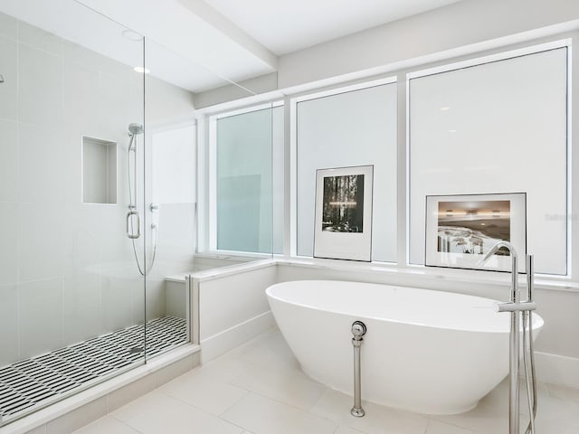 bathroom with tile patterned floors and separate shower and tub