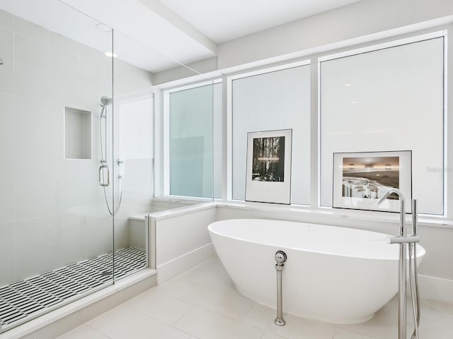 540 N Tamiami Trl Unit 1201, Sarasota, FL 34236 - bathroom featuring a soaking tub, a stall shower, and tile patterned flooring