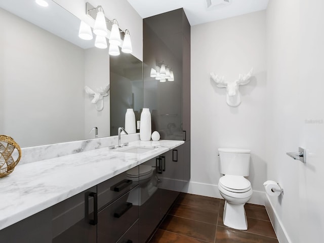 bathroom featuring toilet, vanity, and tile patterned floors