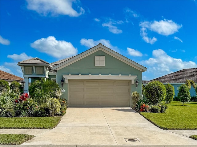 view of front of home featuring a garage and a front yard