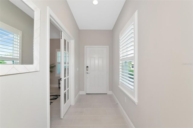 entryway featuring plenty of natural light and light tile patterned flooring