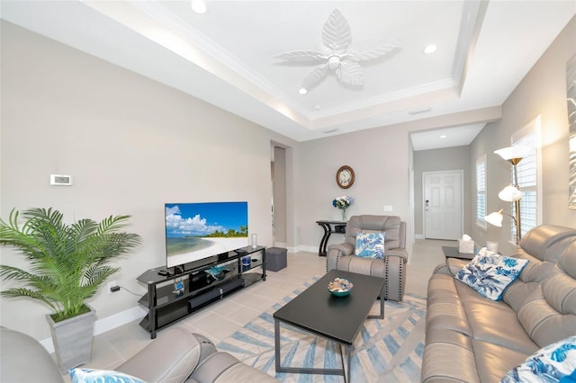 living room featuring a raised ceiling, ceiling fan, ornamental molding, and light tile patterned flooring