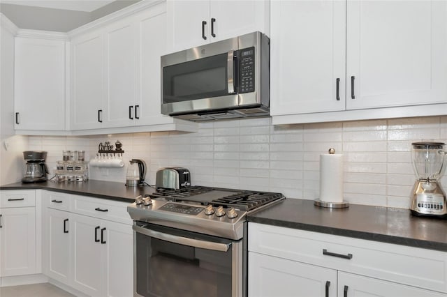 kitchen featuring decorative backsplash, white cabinetry, and stainless steel appliances