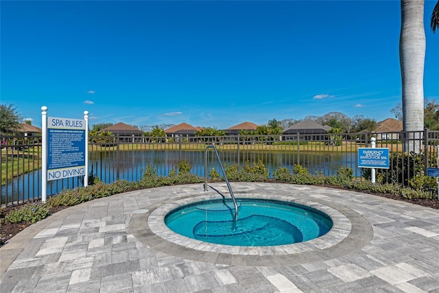 view of swimming pool with a community hot tub and a water view