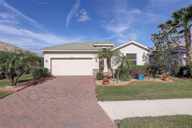 view of front of property featuring a garage and a front lawn