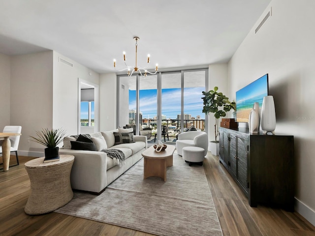 living room with wood-type flooring and a notable chandelier