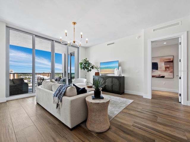 living room featuring dark hardwood / wood-style flooring and an inviting chandelier