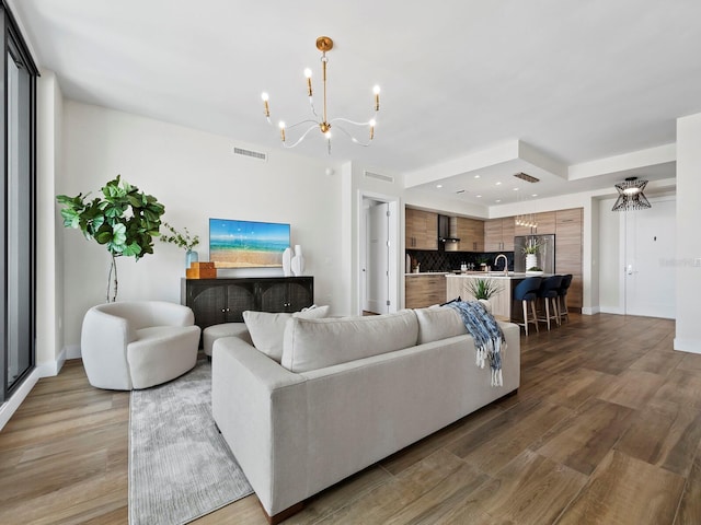 living room with a chandelier and hardwood / wood-style flooring