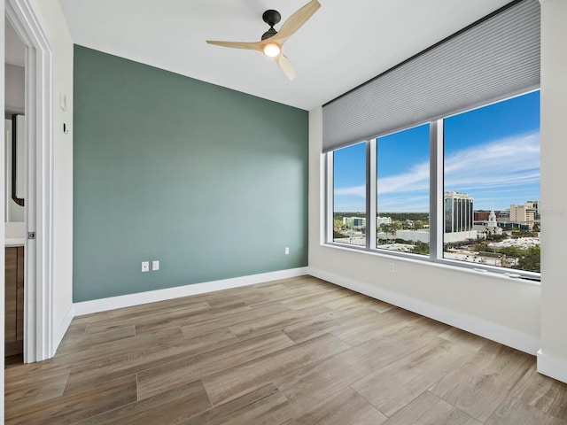 spare room with ceiling fan and light hardwood / wood-style flooring