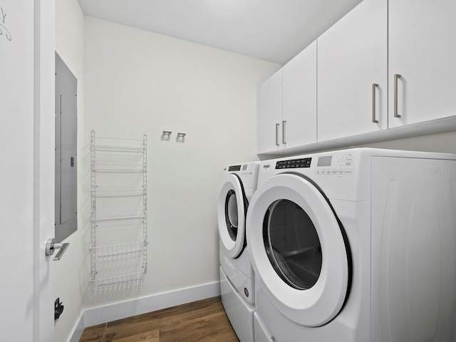 washroom with dark hardwood / wood-style flooring, washing machine and dryer, cabinets, and electric panel