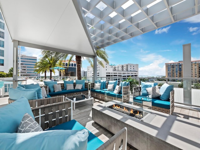 view of patio featuring an outdoor living space with a fire pit