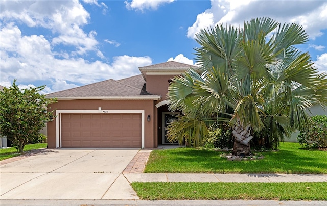 view of front of house featuring a front lawn and a garage