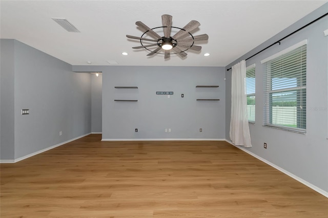 unfurnished room with ceiling fan and light hardwood / wood-style flooring