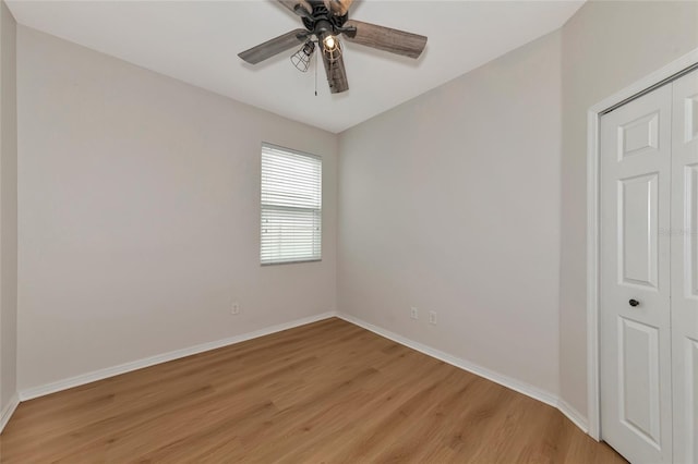 empty room with light wood-type flooring and ceiling fan