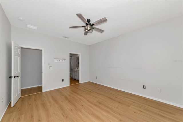 unfurnished bedroom with ensuite bathroom, ceiling fan, and light hardwood / wood-style flooring