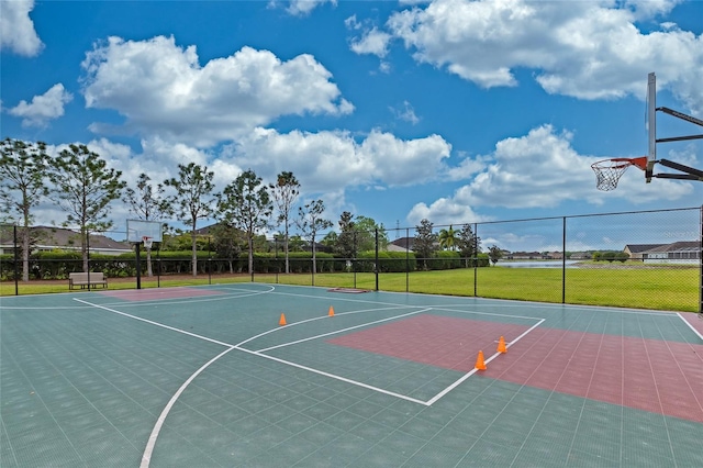 view of basketball court with a yard