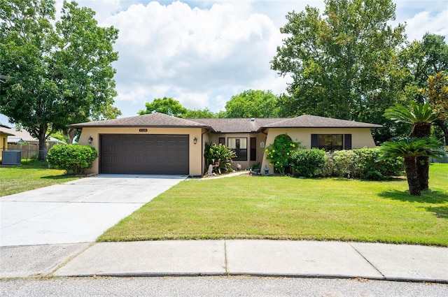 ranch-style house featuring a garage and a front yard