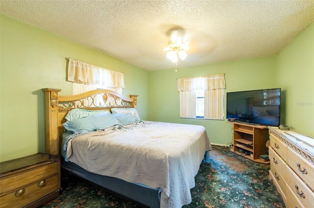 carpeted bedroom with ceiling fan and a textured ceiling