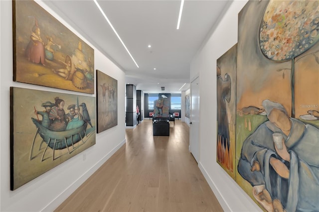 hallway with light hardwood / wood-style flooring