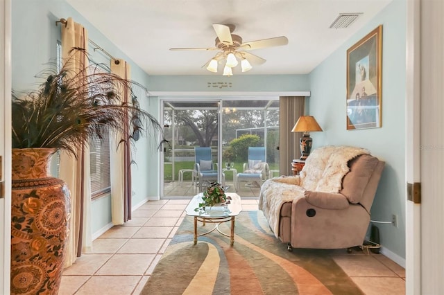 sitting room featuring light tile patterned floors and ceiling fan