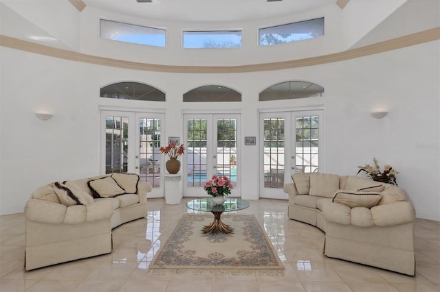 tiled living room with french doors and a high ceiling