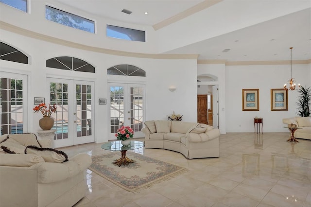 living room featuring an inviting chandelier, a high ceiling, and french doors