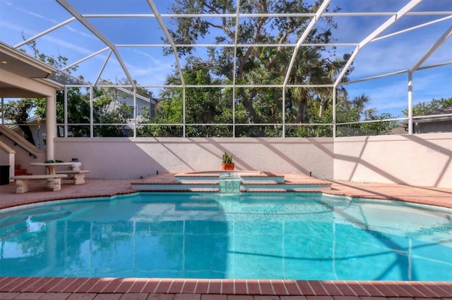 view of swimming pool with a lanai and a patio