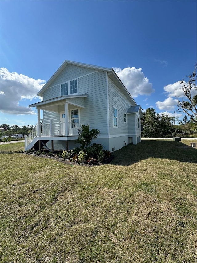 view of home's exterior featuring a yard and covered porch