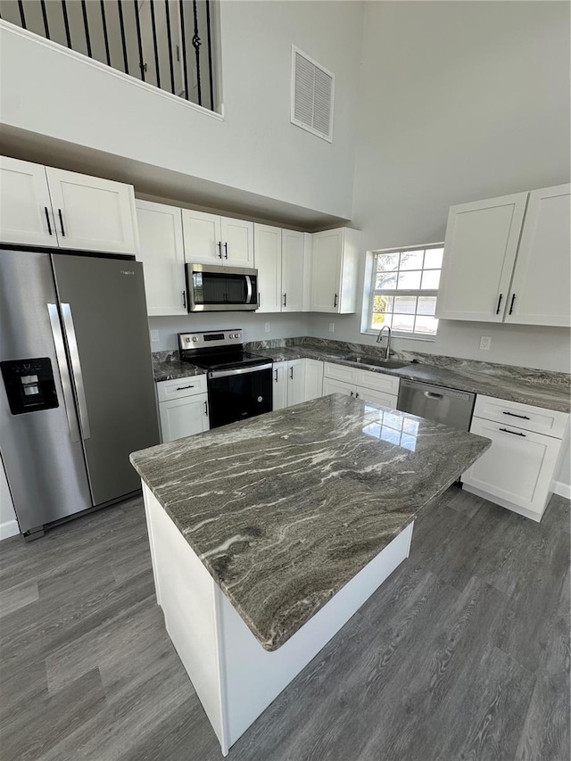 kitchen featuring stainless steel appliances and white cabinetry