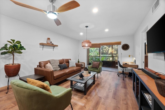 living room featuring hardwood / wood-style flooring and ceiling fan