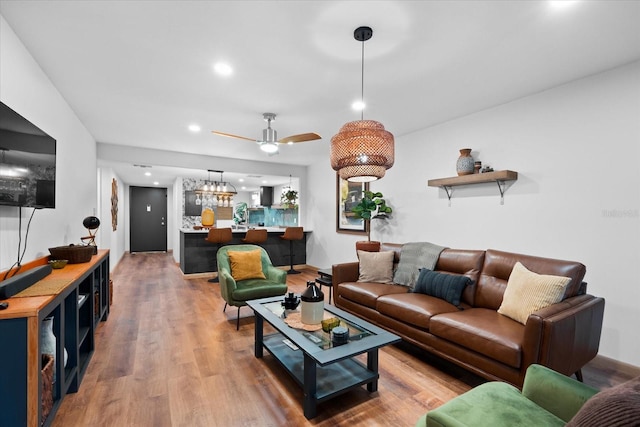 living room with ceiling fan and hardwood / wood-style flooring