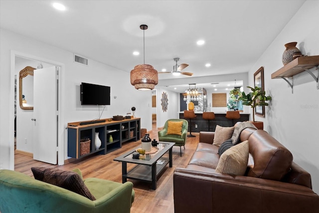 living room featuring ceiling fan and light wood-type flooring