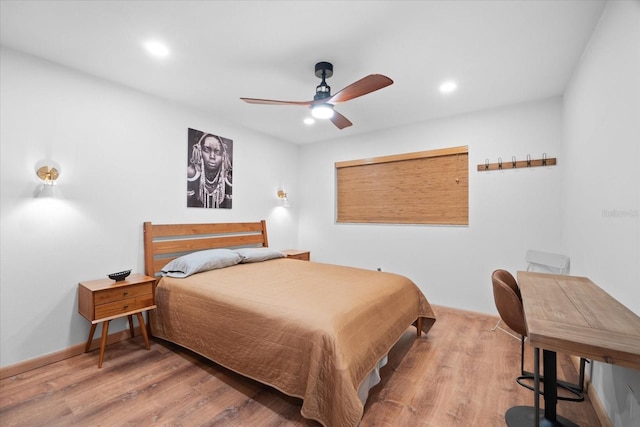 bedroom with hardwood / wood-style flooring and ceiling fan